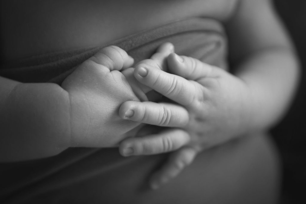 black and white image of baby hands