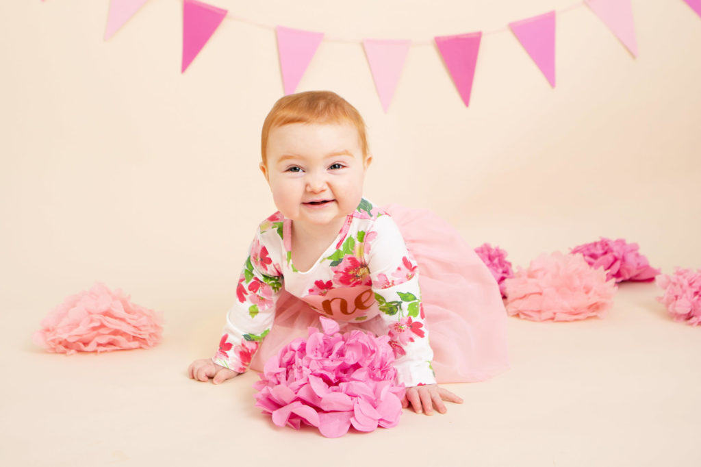 A pink set up with a ginger little girl smiling