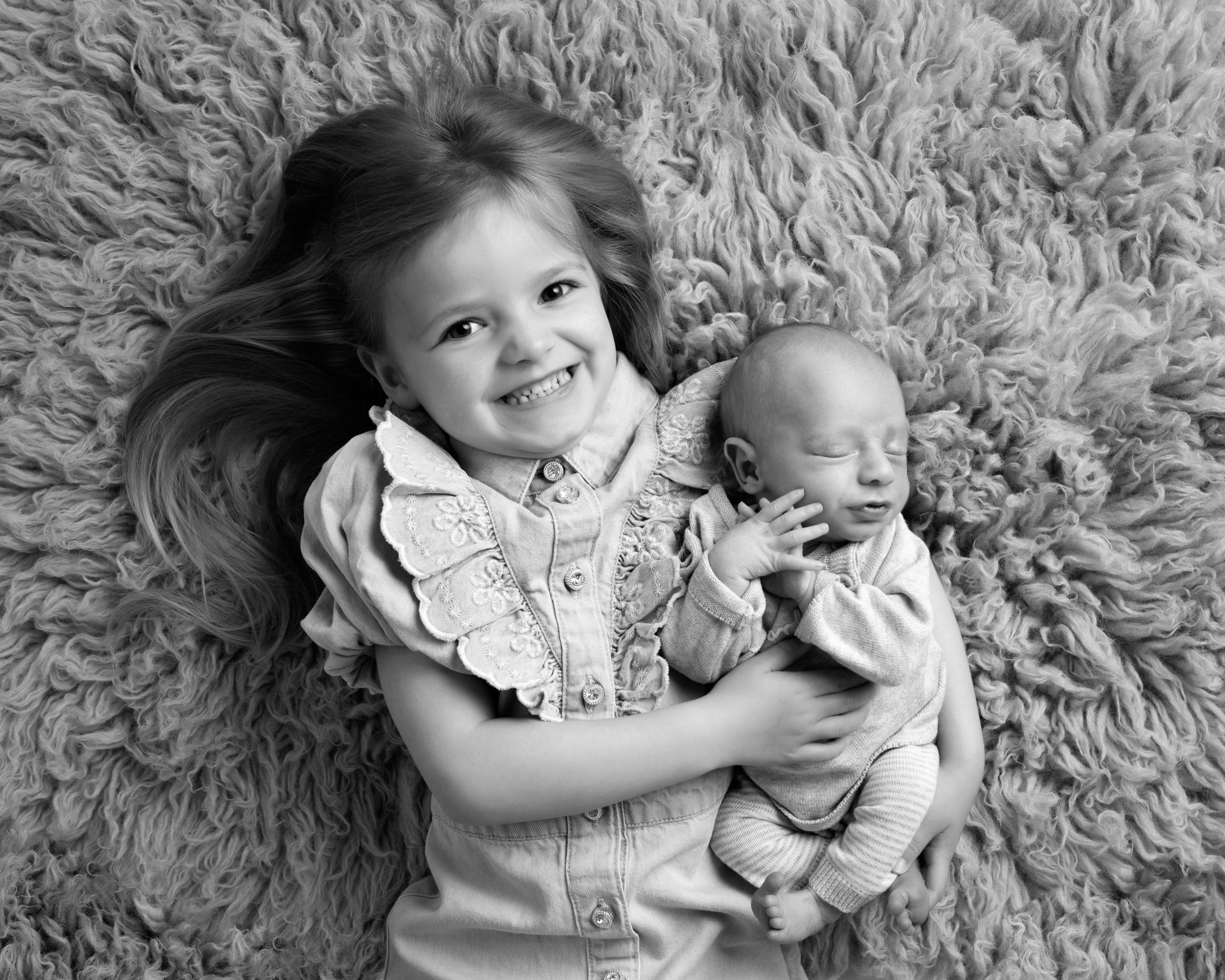 black and white sister holding baby brother